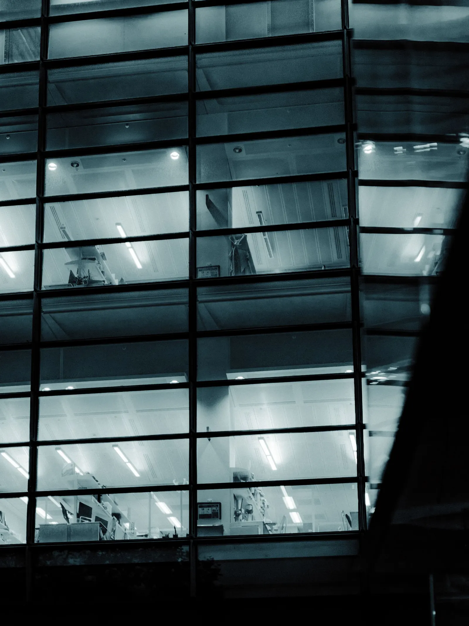 A glass building facade at night