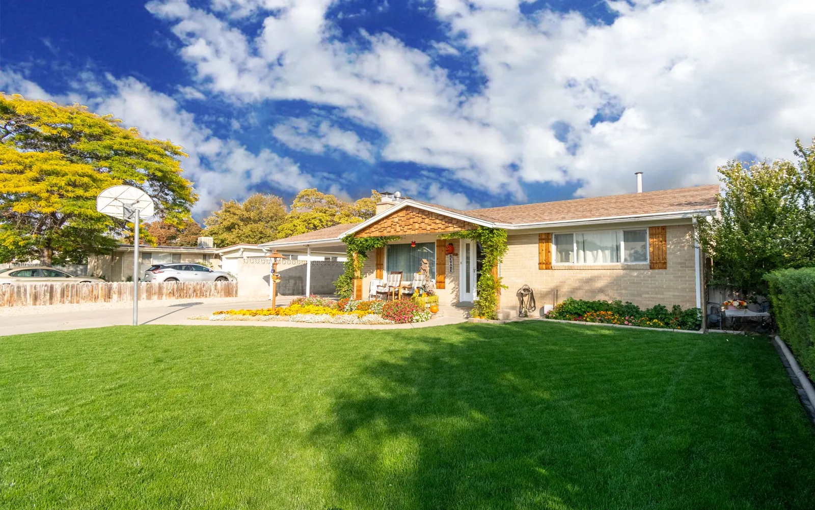 A low ranch house with a large green lawn