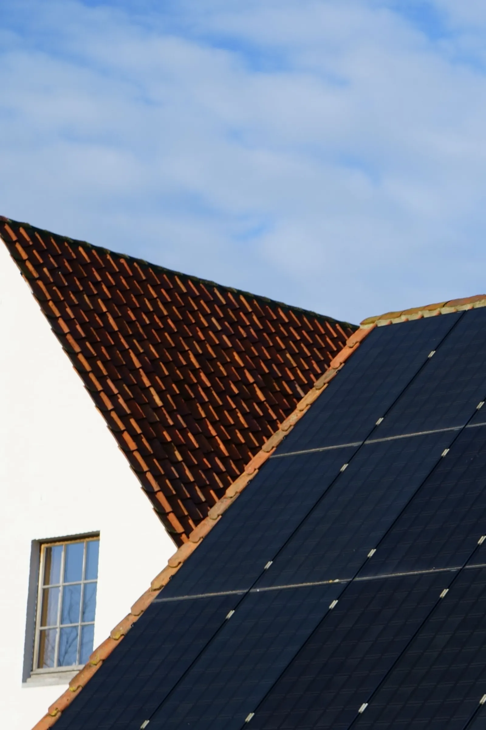 A close view of solar tiles integrated into a pitched roof