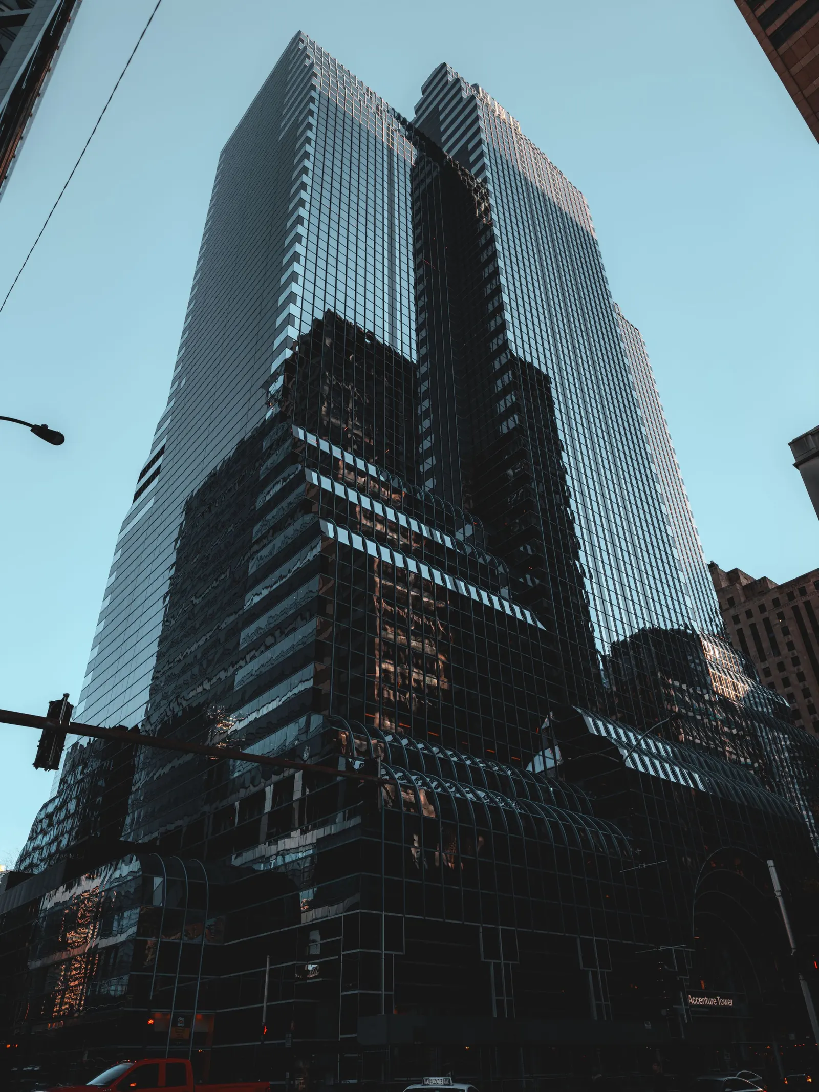 A modern glass tower photographed from street level