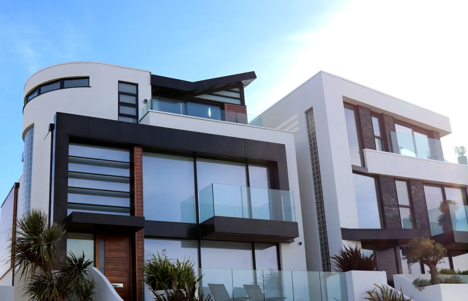 A white modern villa with large glass walls and a flat roof