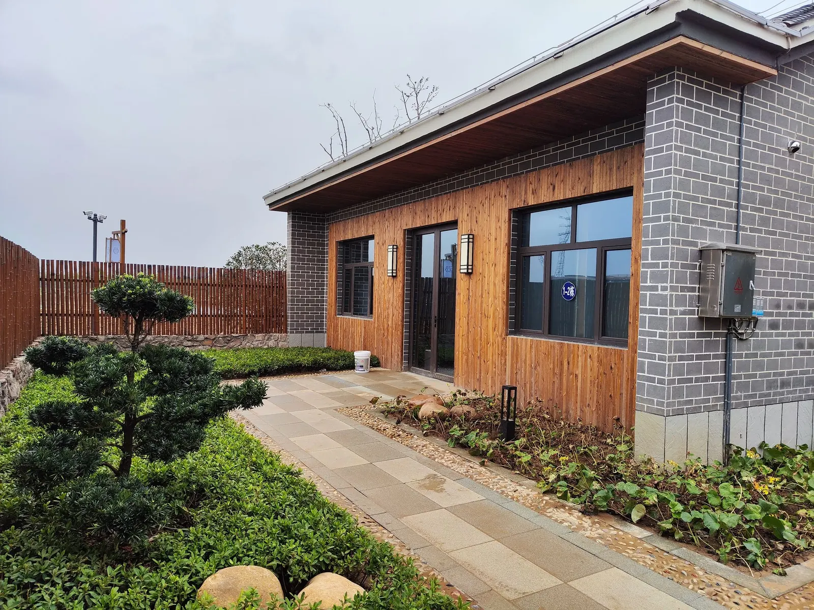 A wood-clad modern house with a garden